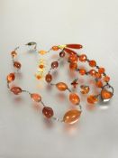 A collection of Edwardian carnelian jewellery to include and graduated bead necklace with white
