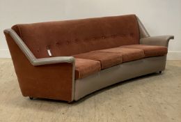 A mid century curvilinear four seat sofa, circa 1950's, upholstered in plush plum and vinyl and
