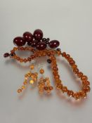 A collection of amber beads and mounted jewellery to include a strand of graduated mid coloured