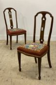 A pair of Edwardian walnut side chairs, the pierced splat back with boxwood stringing, above a