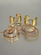 A pair of silver gilt semi precious stone set cuff style bracelets with peridots, amethysts etc  H x