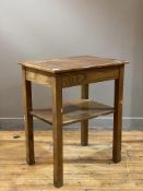 An early 20th century oak two tier lamp table, the rectangular top raised on square section