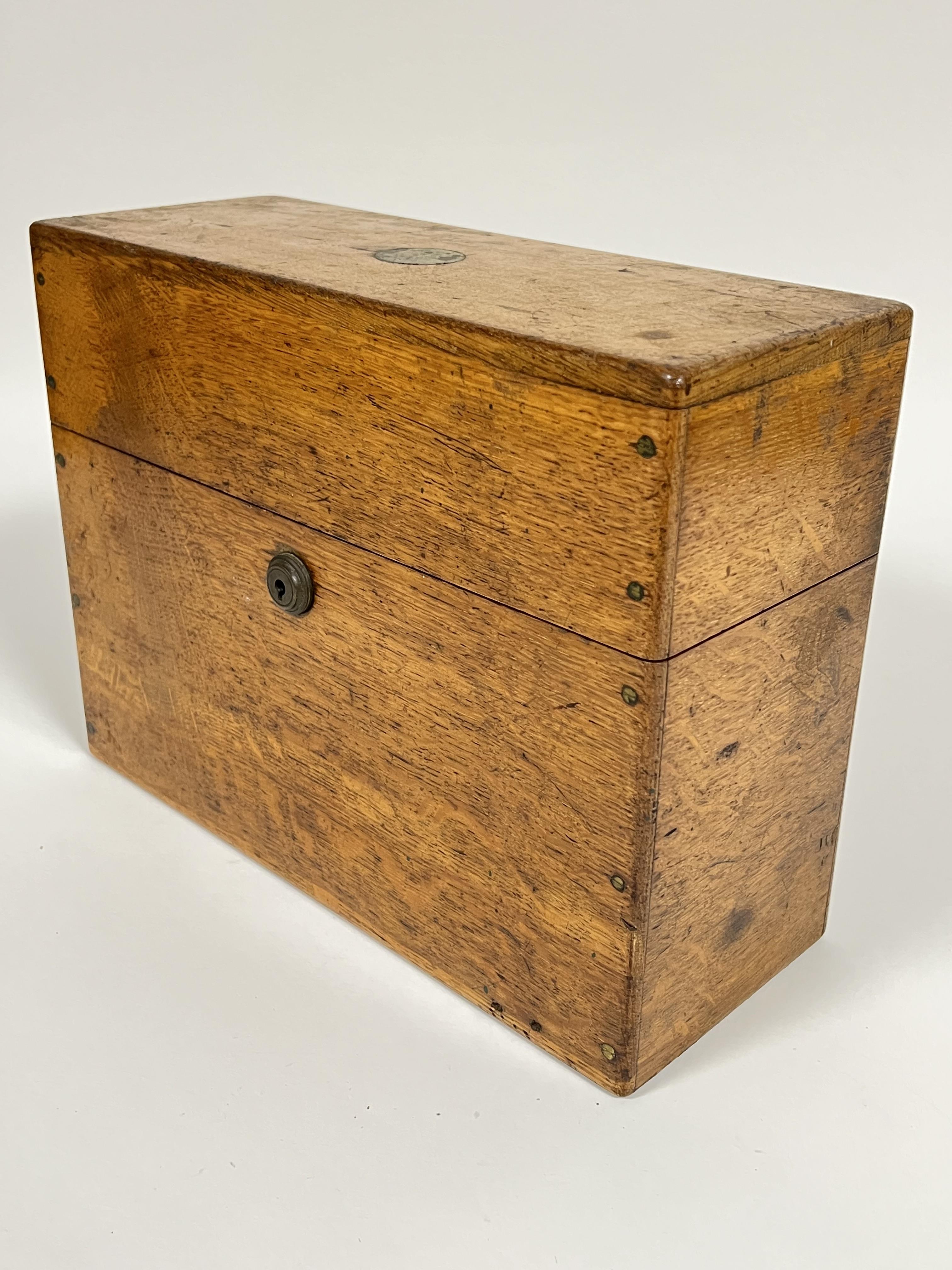 An early twentieth century leather lined oak spirits container/tantalus with three clear glass - Image 3 of 4