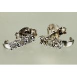 A pair of silver earrings set three 0.05ct diamond in claw setting L x 0.5cm