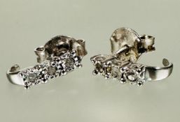 A pair of silver earrings set three 0.05ct diamond in claw setting L x 0.5cm