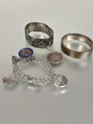 A group of three bracelets to include a 9ct gold on silver engraved stiff hinged bangle with