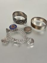 A group of three bracelets to include a 9ct gold on silver engraved stiff hinged bangle with