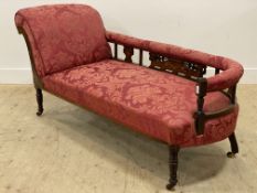 A late Victorian rosewood framed chaise longue, the back, seat, and arm rest upholstered in red