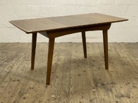 A mid century walnut extending dining table, the rectangular top raised on square section