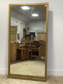A large late 19th / early 20th century wall mirror, the frame painted gold (alterations) 175cm x