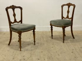 A pair of Victorian Aesthetic movement walnut framed side chairs, the crest rail and splat with