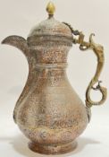 A Middle Eastern copper and brass coffee pot of traditional form with chased decoration of