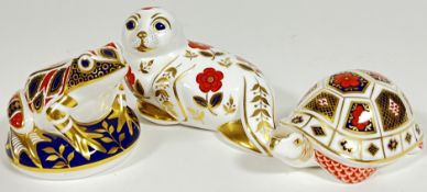 A collection of three Royal Crown Derby paperweights comprising a gold stopper frog, a seal with