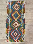 A Chobi kilim flat weave runner rug of characteristic design 148cm x 63cm