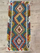 A Chobi kilim flat weave runner rug of characteristic design 148cm x 63cm