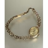 A ladys 9ct gold Sovereign quartz wristwatch of oval design with gilt metal dial on 9ct gold link