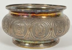 A Malaysian silver or white metal bowl with repousse decoration of crests of twelve states (Malacca,