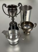A Birmingham silver miniature two handled cup on moulded plastic stand base has a bump H x 11cm