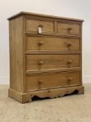 A Victorian style pine chest, fitted with two short and three long graduated drawers, raised on a