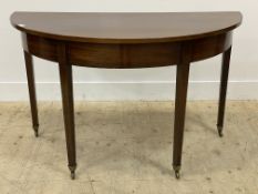 A 19th century mahogany demi lune console table, the square tapered supports terminating in brass