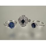 A group of three 9ct white gold gem set rings to include an oval cut blue stone ring with surround