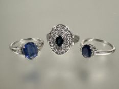 A group of three 9ct white gold gem set rings to include an oval cut blue stone ring with surround
