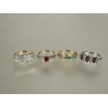 A group of four silver gem set rings to include a five stone cushion cut ring, a three stone green