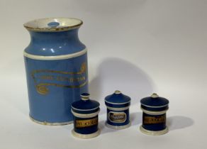 A collection of Chemist/ Apothecary jars and covers, one light blue large jar with band reading "