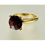 A 9ct gold red stone solitaire ring set in four claw setting approximately 2ct N 2.98g