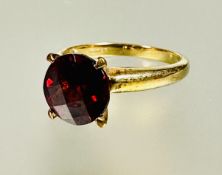 A 9ct gold red stone solitaire ring set in four claw setting approximately 2ct N 2.98g