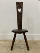 An early 20th century floral carved oak spinning chair, raised on turned supports. H90cm.