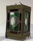 An Arts and Crafts period hall lantern of rectangular outline, the brass case embossed with floral