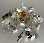 A collection of twenty two pairs of silver earrings to include amber set earrings, a pair of