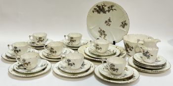 A gilt floral china part tea service comprising eight cups, eleven saucers, ten tea plates, two