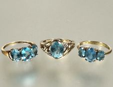 A collection of three 9ct gold blue zircon set rings including two three stone graduated rings and