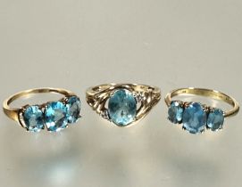 A collection of three 9ct gold blue zircon set rings including two three stone graduated rings and