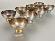 A set of eight Chinese white metal rice wine toasting cups with engraved with allover flower and