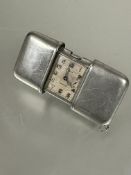 A 1930s vesta case style vintage Movado steel pocket travelling clock with slide open sides silvered