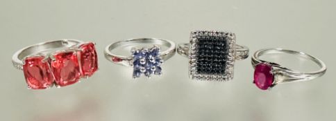 A collection of three silver coloured stone set dress rings and a silver black diamond pave set ring
