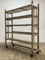 A late 19th / early 20th century cobblers shoe rack or bakers trolley, five slatted tiers on