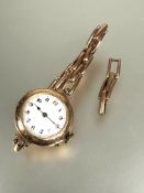 A ladys vintage 9ct gold wristwatch with white enamel dial and arabic numerals D x 2cm on