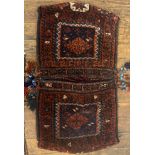 A hand knotted wool Baluchi saddle bag of typical design. 105cm x 58cm.