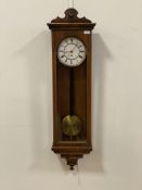 A late Victorian rosewood and mahogany cased Vienna type wall clock, having a white enamelled dial