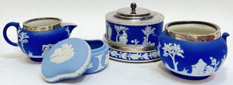 A group of Wedgwood Jasperware comprising a silver topped milk jug, a silver topped sugar bowl, a