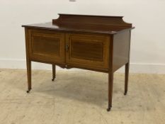 An Edwardian mahogany wash stand, the raised back with boxwood string inlay above two doors,