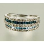 A 9ct white gold half eternity style ring twin channel set caliber green stones flanked enclosed