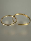 A 18ct gold wedding band M/N 1.5g and a yellow metal wedding band cut 1.1g (2)