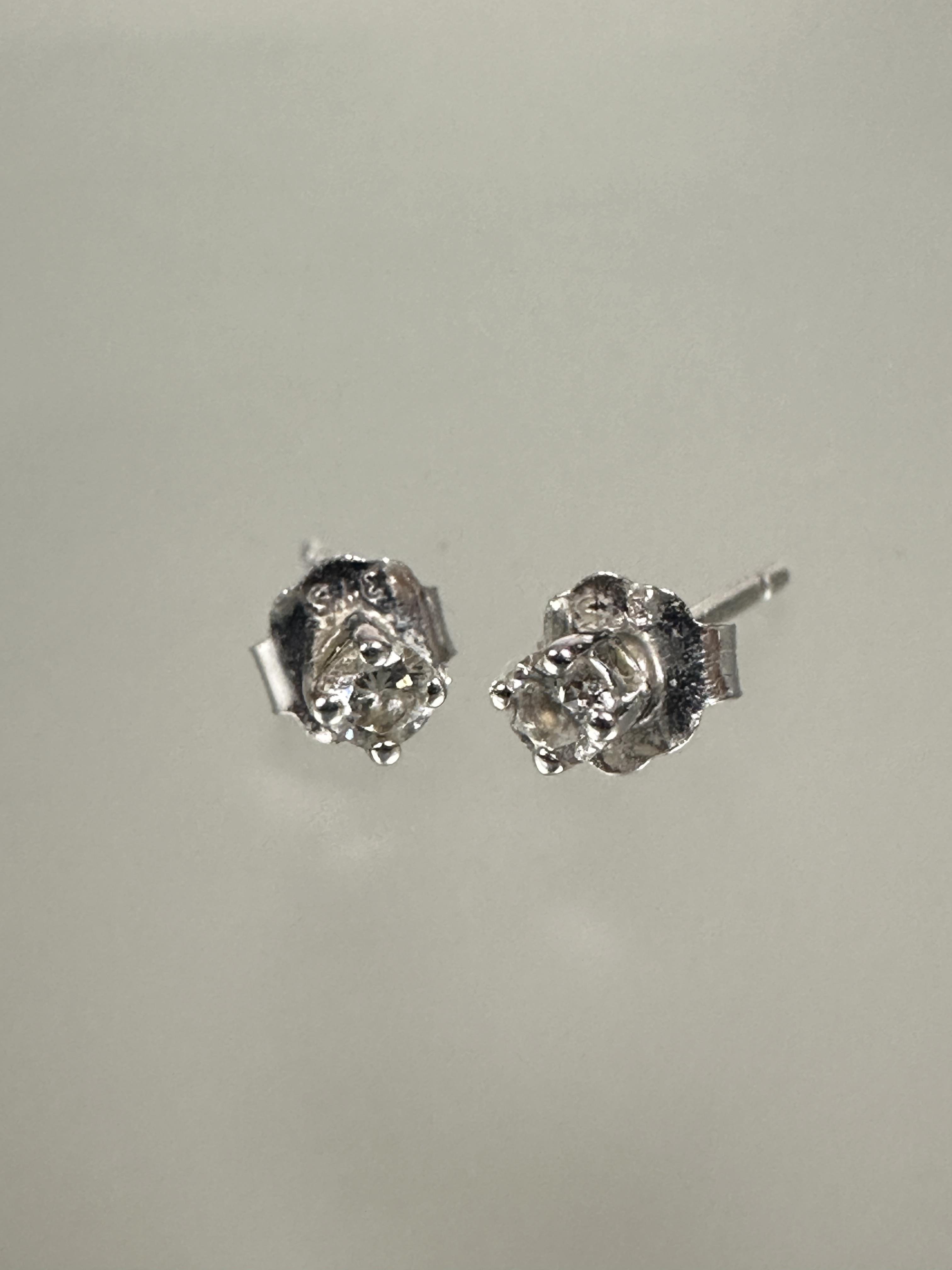 A pair of 9ct white gold set diamond stud earrings in claw setting approximately 0.05ct and a pair - Image 2 of 2