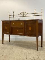An Edwardian mahogany serving table in the Sheraton style, with gilt brass gallery back above a