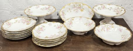 An Edwardian Limoges porcelain dessert service with scalloped borders comprising two comports, three